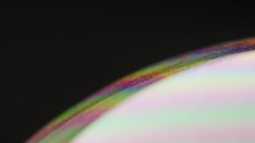 Particles move across colorful abstract arc