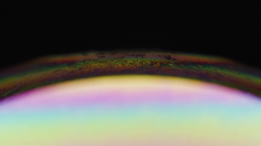 An abstract round object with a multicolored and rotating surface