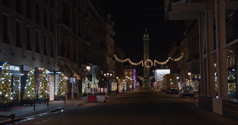 The street is decorated with holiday lights