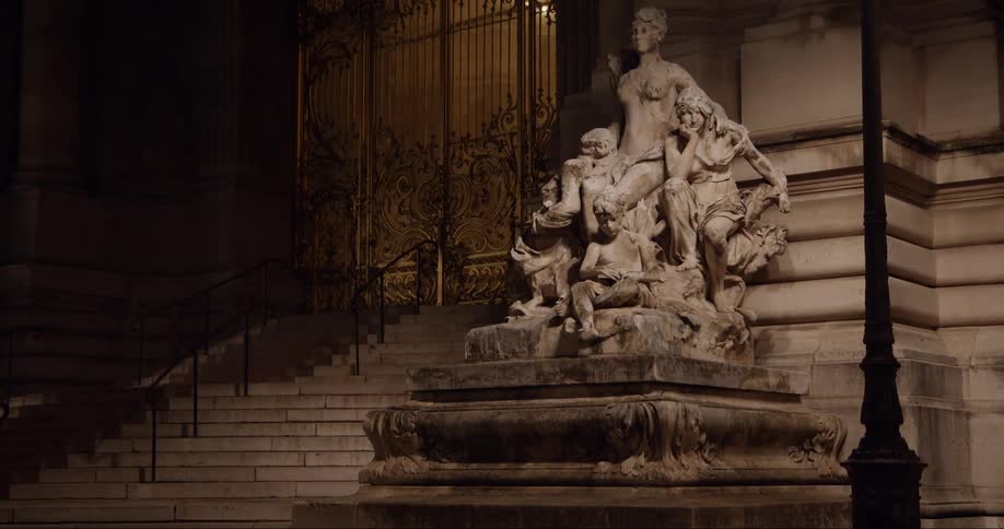A statue of a group of people are in front of the building