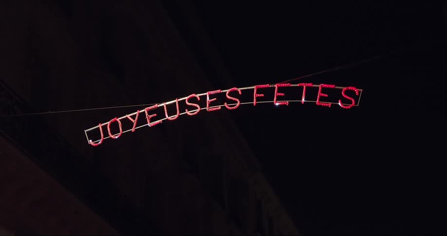 A lighted sign hangs at night
