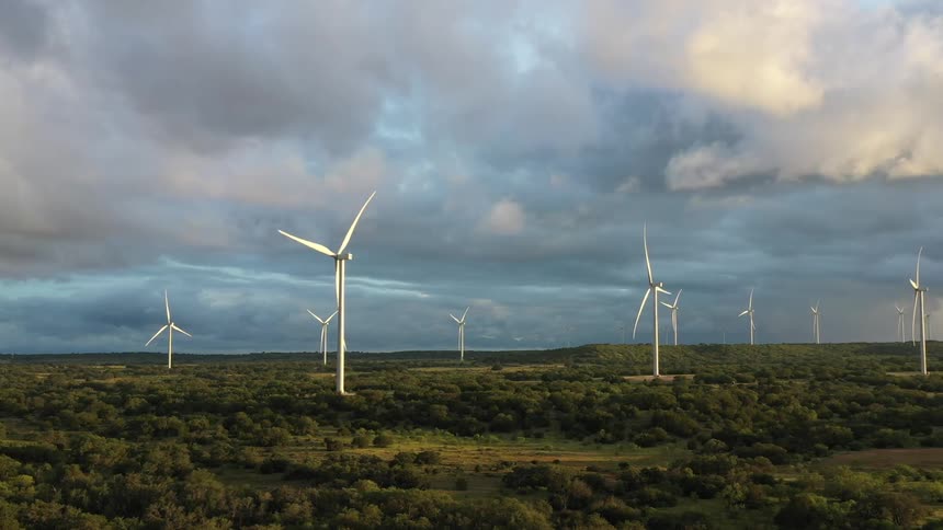 Modern windmills on a grassy field