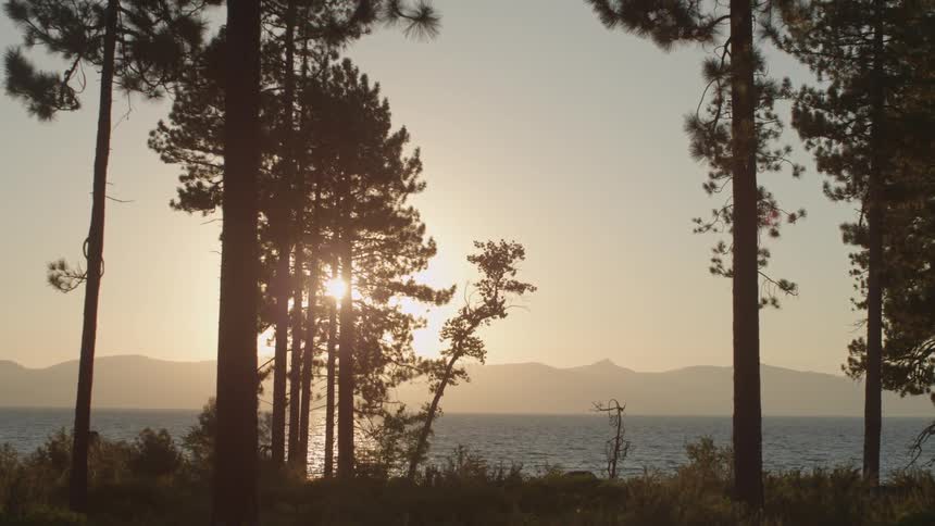 The sun is setting beyond the water ahead