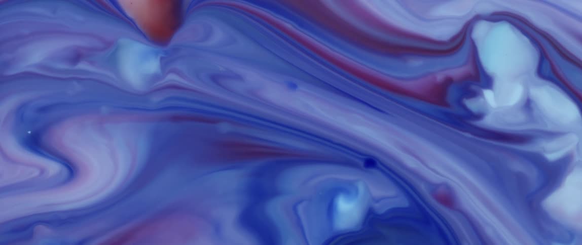 A colored liquid with a predominant blue color moving upwards