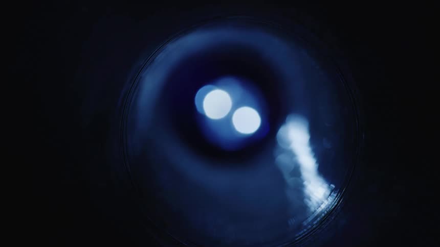 A round dark tube being illuminated by a strong and bright light