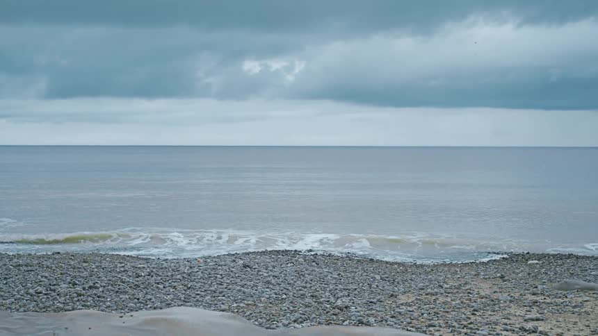 Small waves at the beach at midday