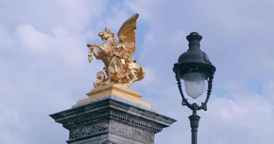 A golden statue is on the pillar