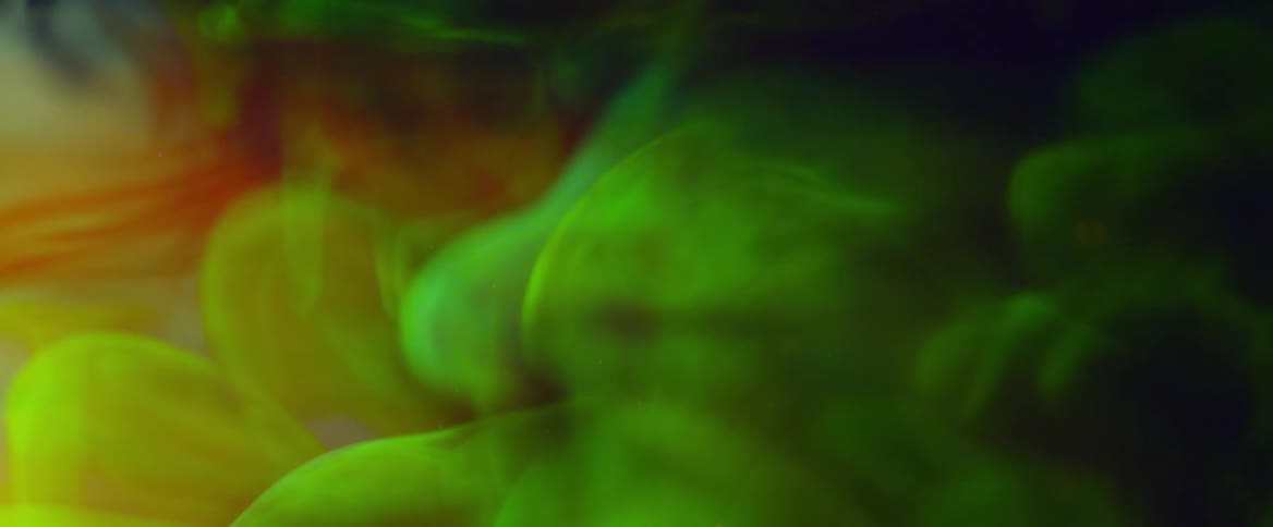 Green smoke rises gracefully forming ethereal patterns in the air