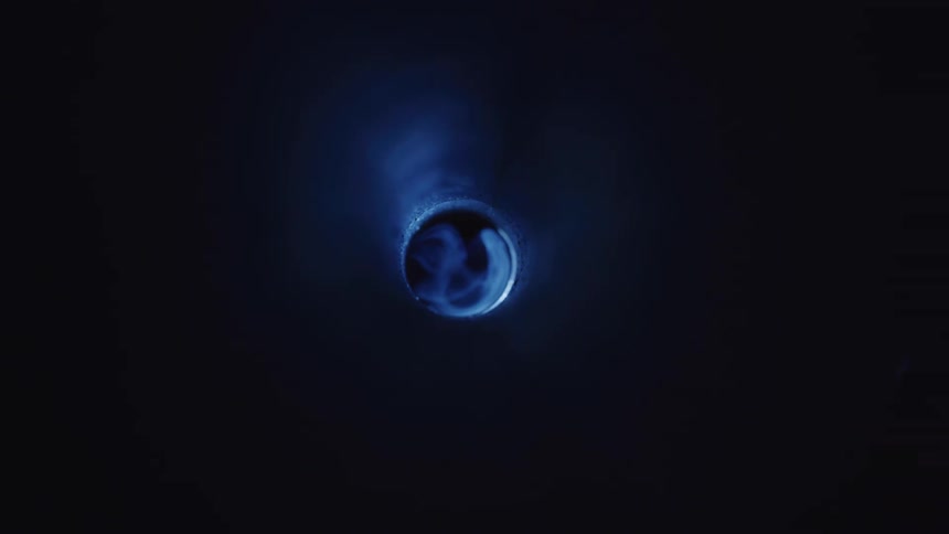 A hole being illuminated by a passing blue object