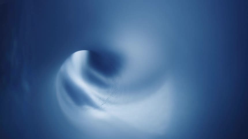 A blue light illuminating the walls of a smooth tunnel
