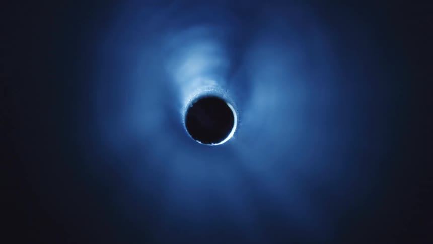 A circle lit up against a black background showing a light blue casting