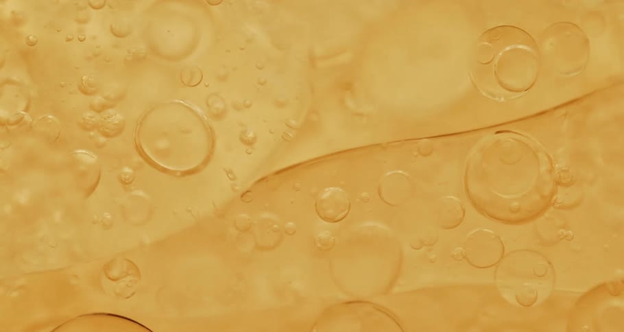 Dense abstract bubbles in microscopic orange liquid in motion
