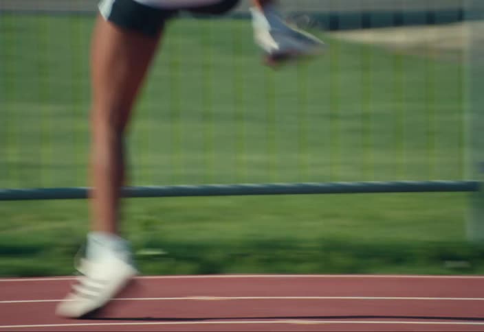 A runner warming up for a race on a track