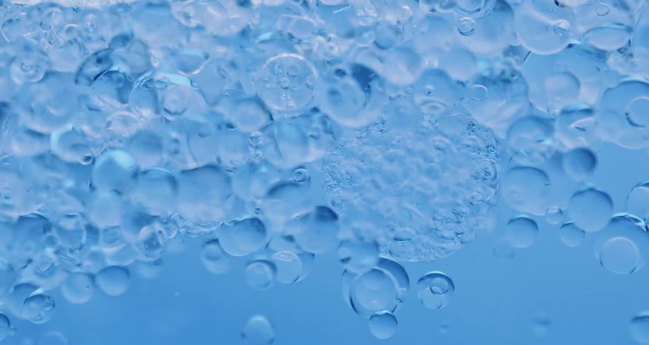 Air bubbles moving on a blue liquid