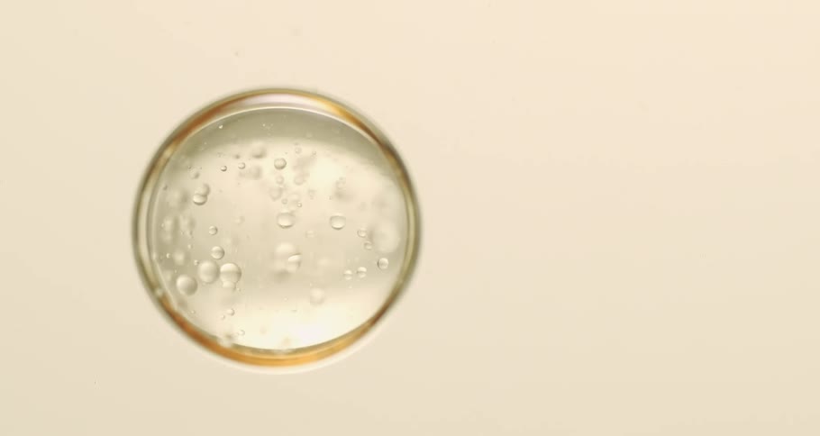 Air bubbles float down a clear liquid
