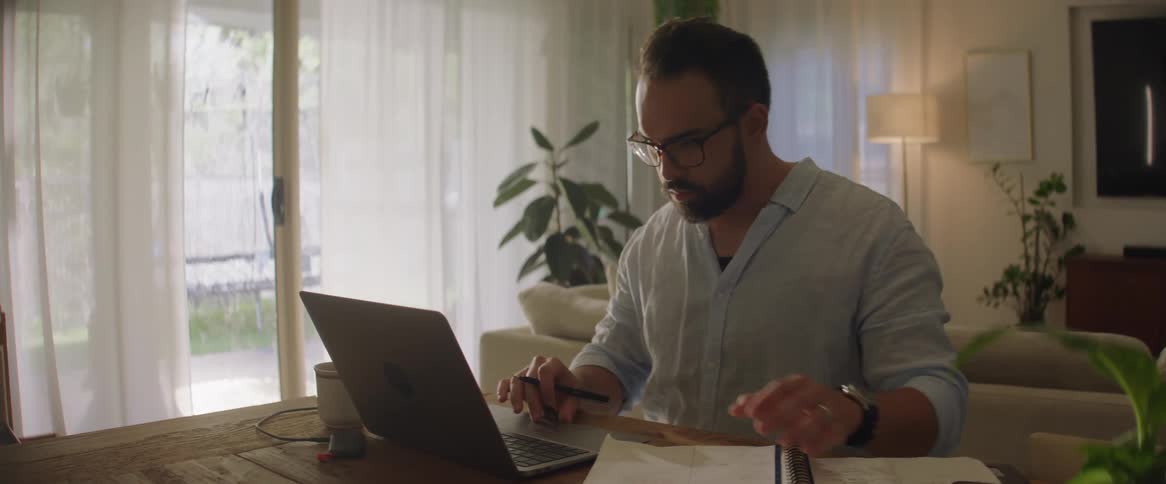 A man is working on his laptop