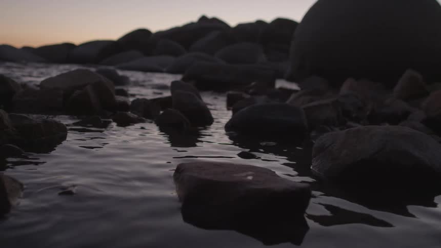 Water moves around these rocks at dawn