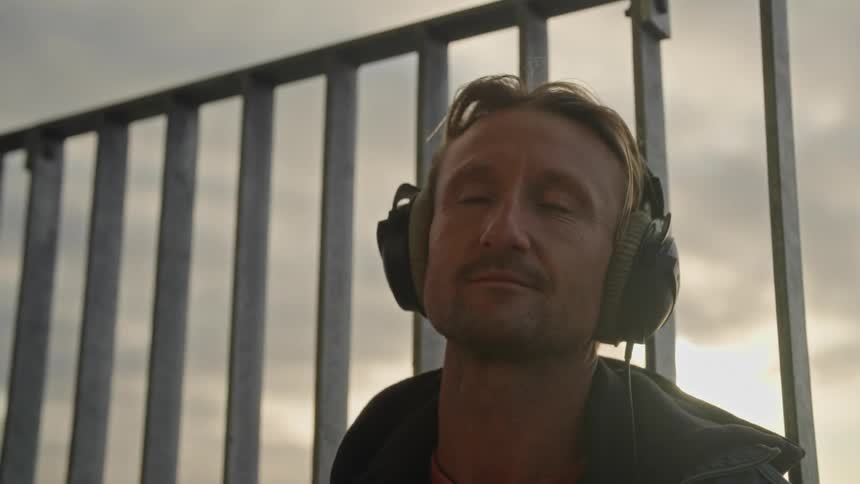 Portrait of a man wearing headphones with a happy and emotional facial expression