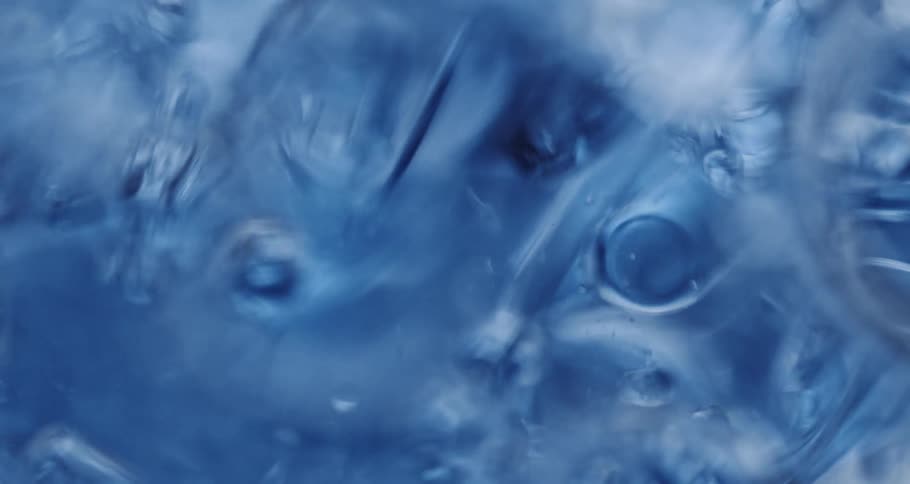 Bubbles flow through blue tinted water