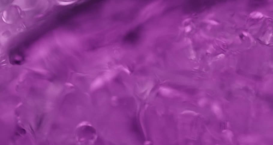 Light purple translucent liquid bubbles flow quickly