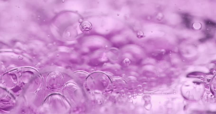 Purple foam flows slowly across surface