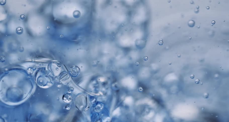 Clear water with bubbles splashes in slow motion