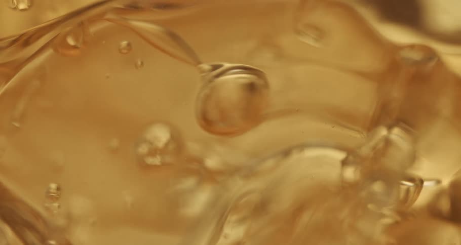 Golden liquid with abstract bubbles in motion