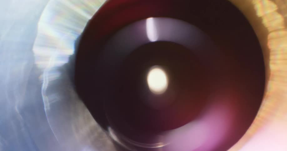 Colorful lights reflect and flare on a lens