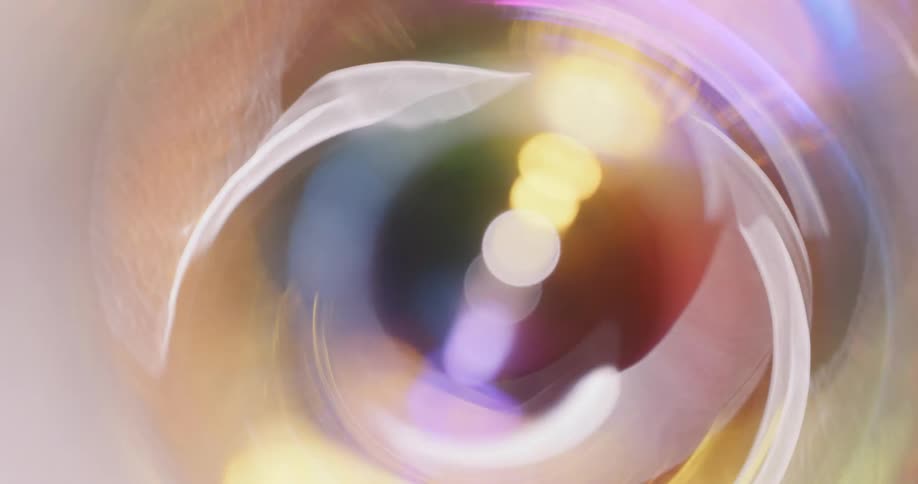 Colorful lights reflect and flare on a lens