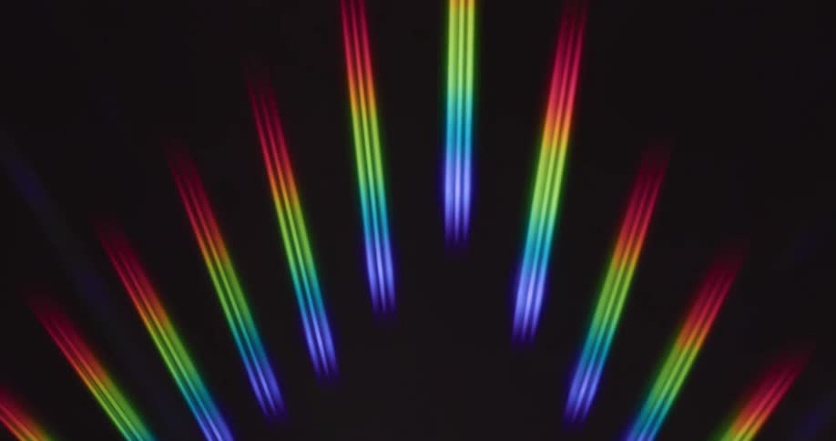 Abstract rainbow light patterns on a black background