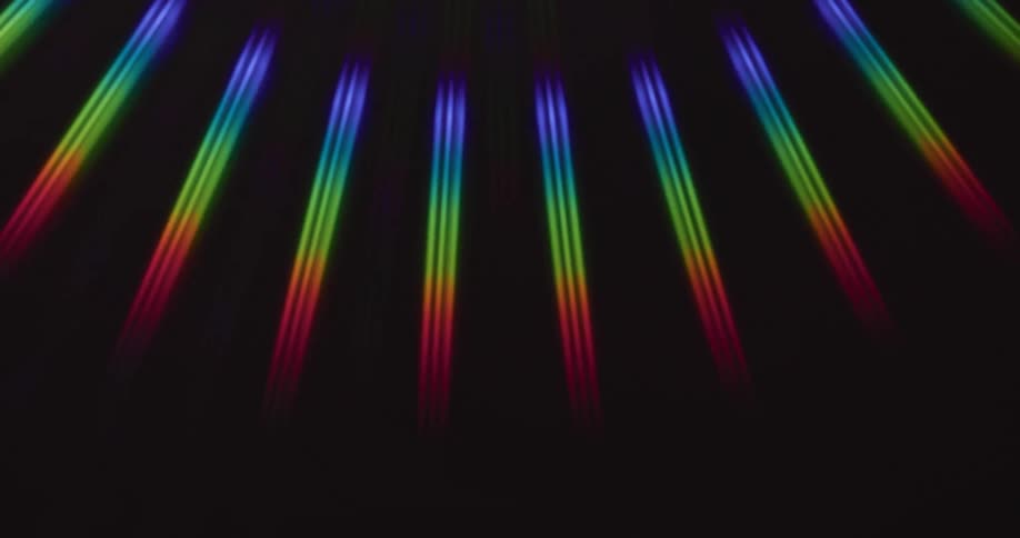 A row of rainbow lights move back and forth in a fanned out pattern