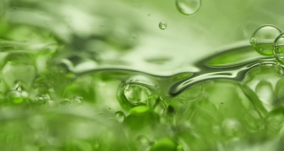 Bubbles roil through green carbonated beverage