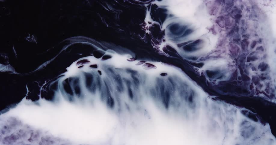 Waves of white and purple liquid ink over a black background