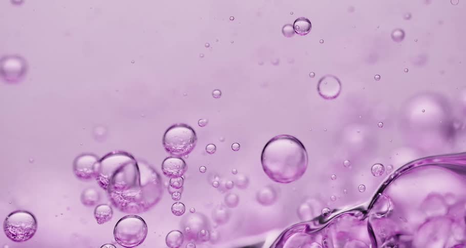 Bubbles of various sizes float through beverage