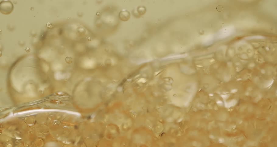 Clear soapy bubbles rising and falling slowly in waves