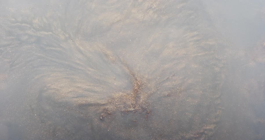 Dense liquid and abstract sandlike texture in a suction motion