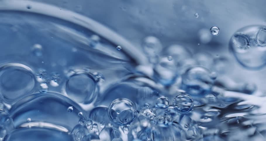 Air bubbles slowly move through a thick blue liquid