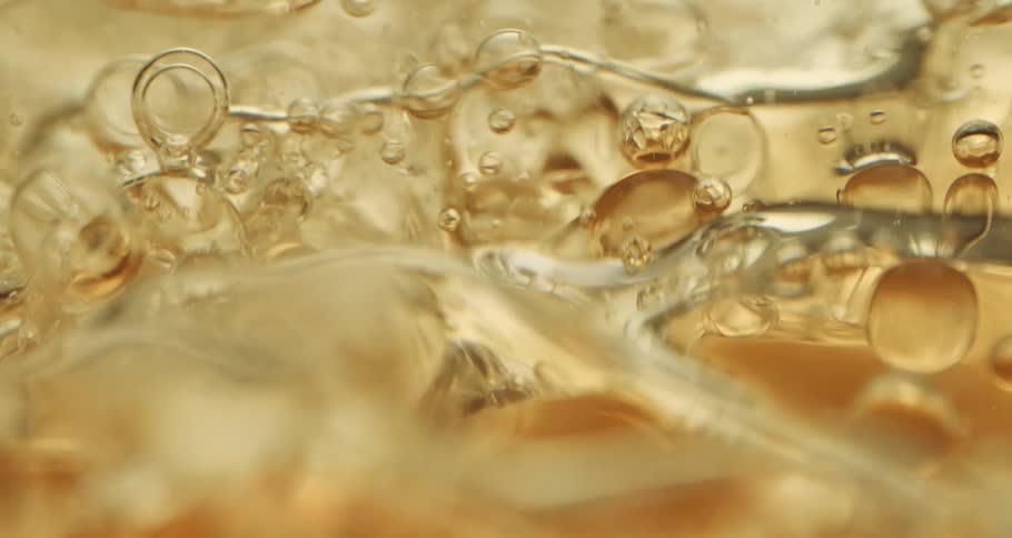 Bubbles float through amber beverage