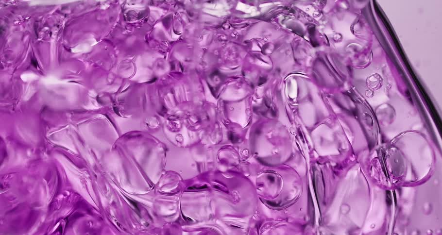 Several bubbles flow through lavender fluid
