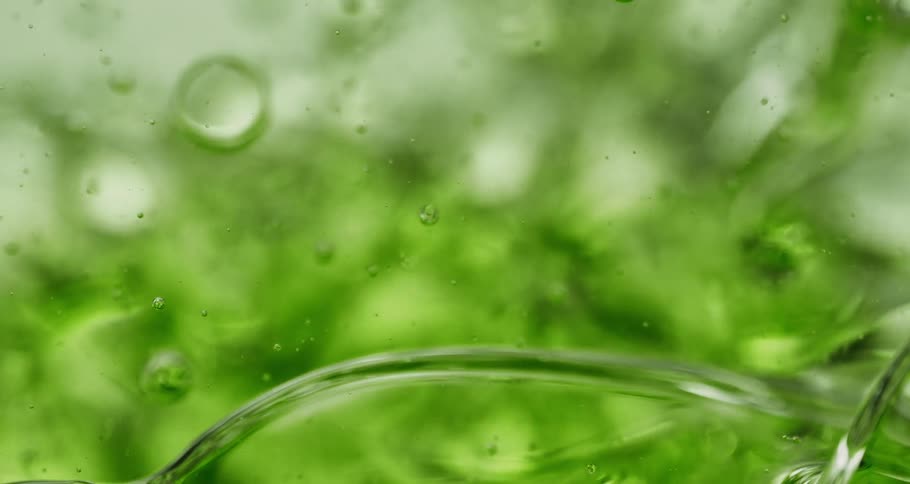 Bubbles float through roiling green beverage