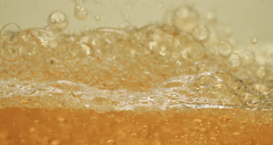 Clear soapy liquid bubbling and moving around slowly
