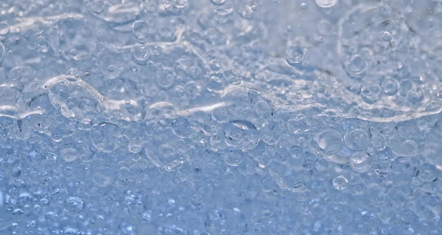 Air bubbles slowly move through a thick blue liquid