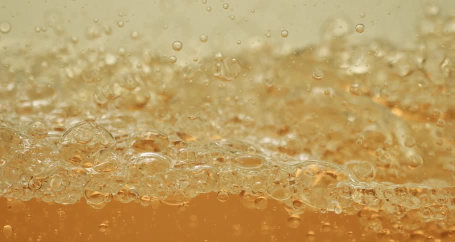 Golden liquid with abstract bubbles in motion
