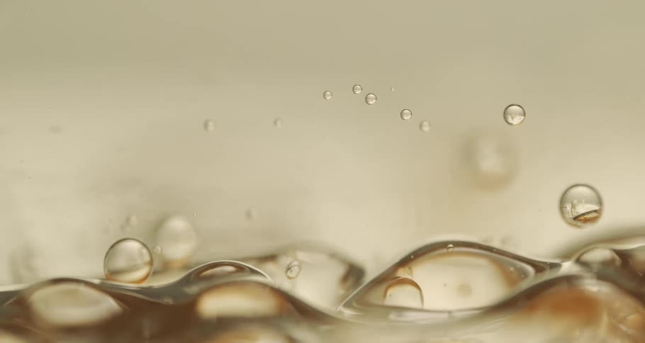 Drops fly into the air from roiling carbonated beverage