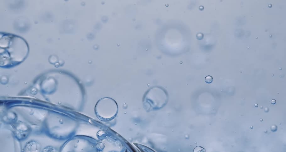 Air bubbles slowly move through a thick blue liquid