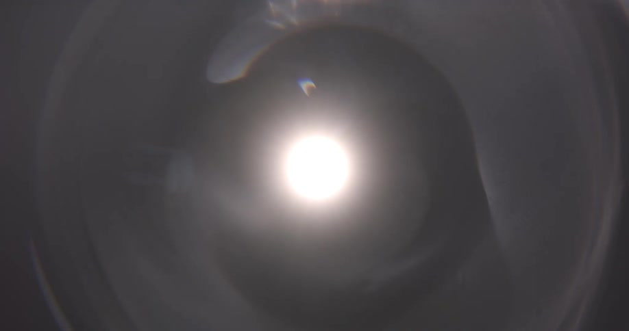 A sphere glows in the darkness and a tunnel emerges as the light shines