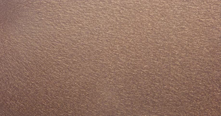 A beige texture with several moving and shining dots