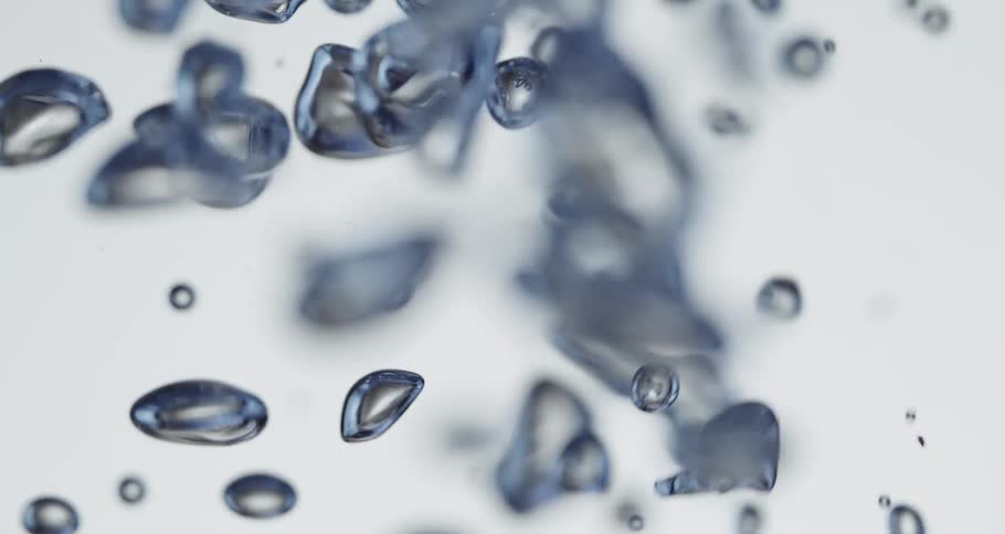 Air bubbles floating up and down clear water