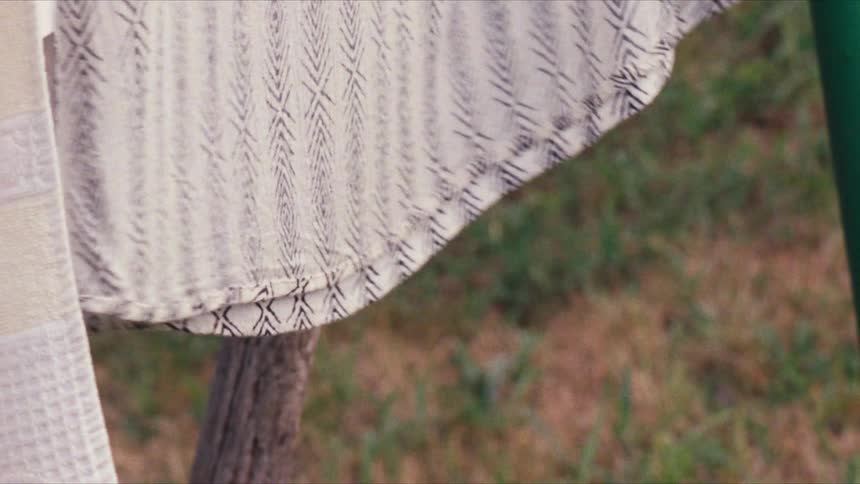 Clothes hanged to dry wave in the wind