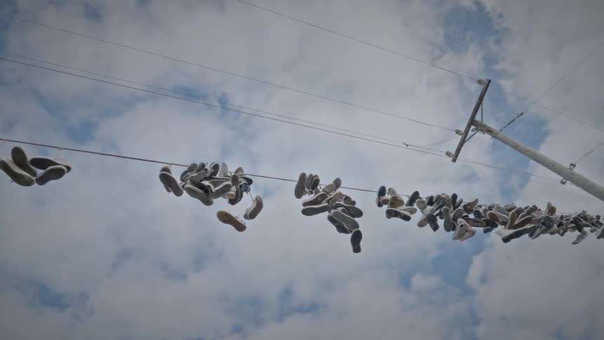 Several sneakers hang from powerlines